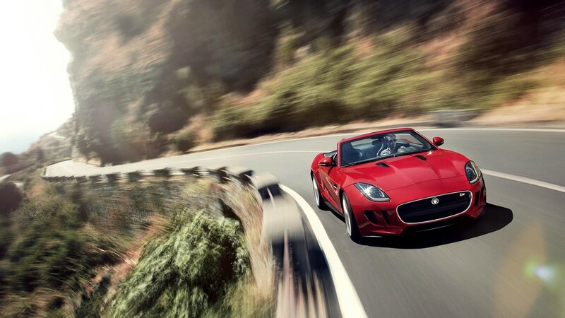 Red sports car on winding road