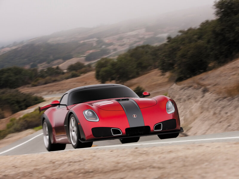 red sports car on winding road