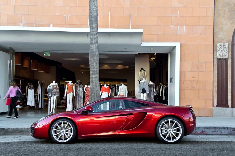 Red sports car outside boutique