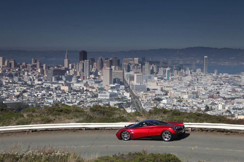 Red sports car overlooking city