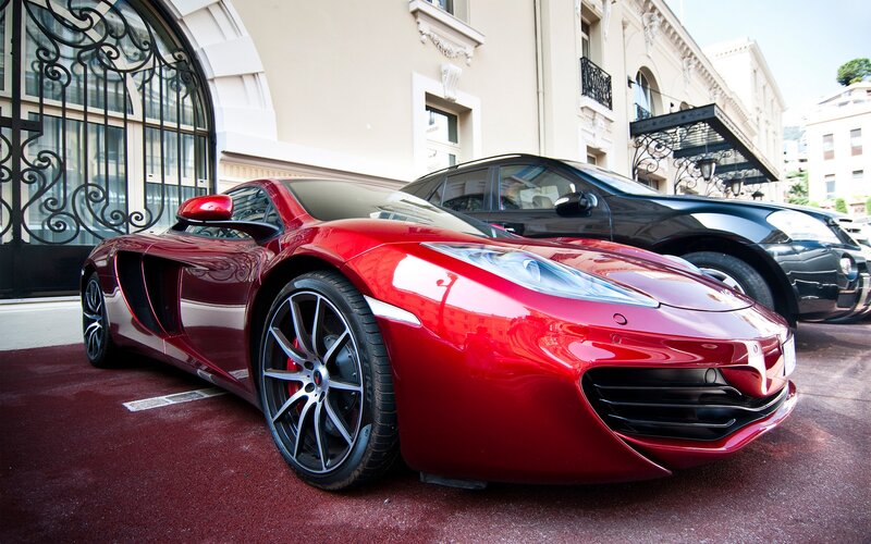 Red sports car parked outside building