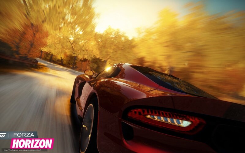 Red sports car racing at sunset