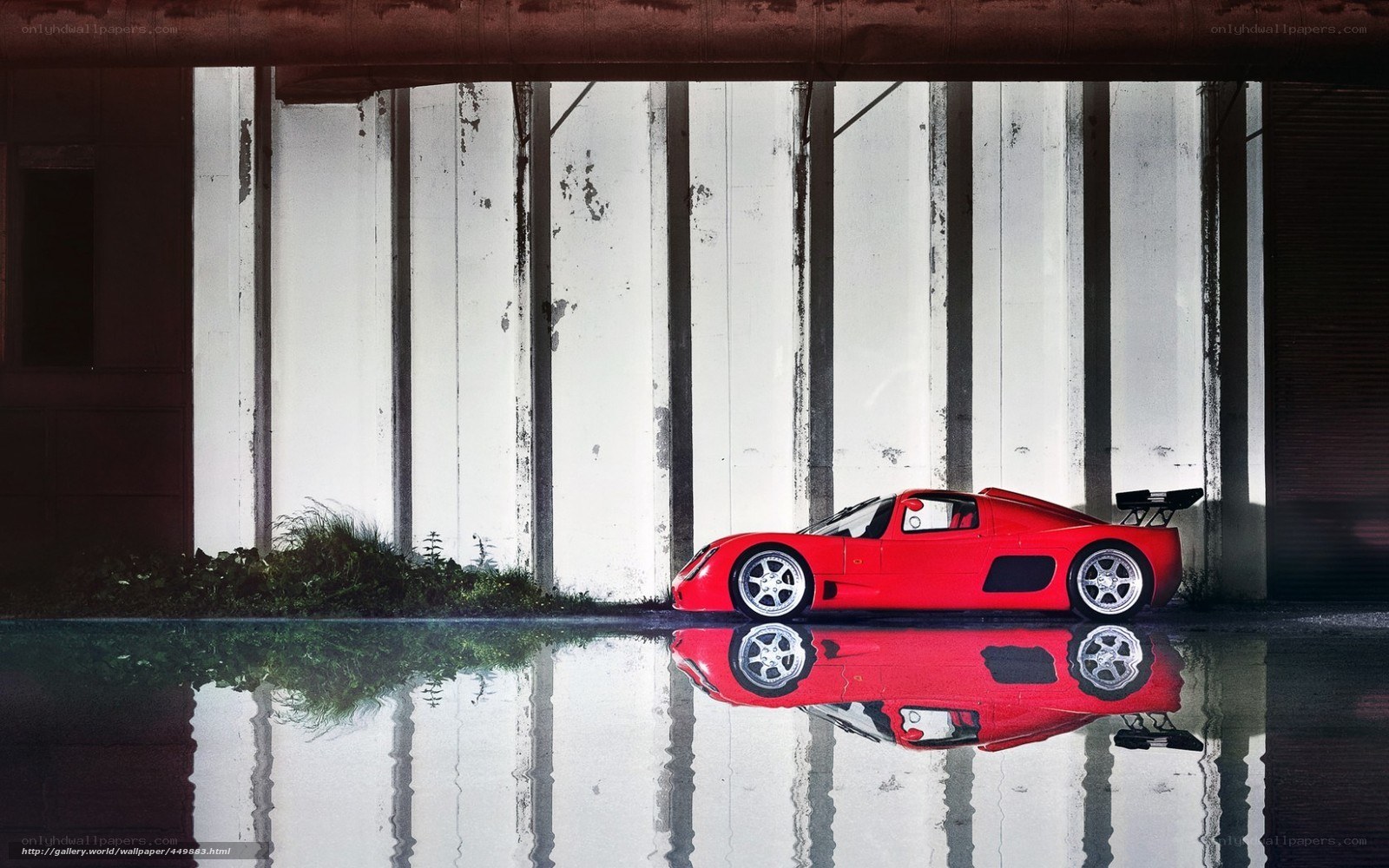 Red sports car under bridge