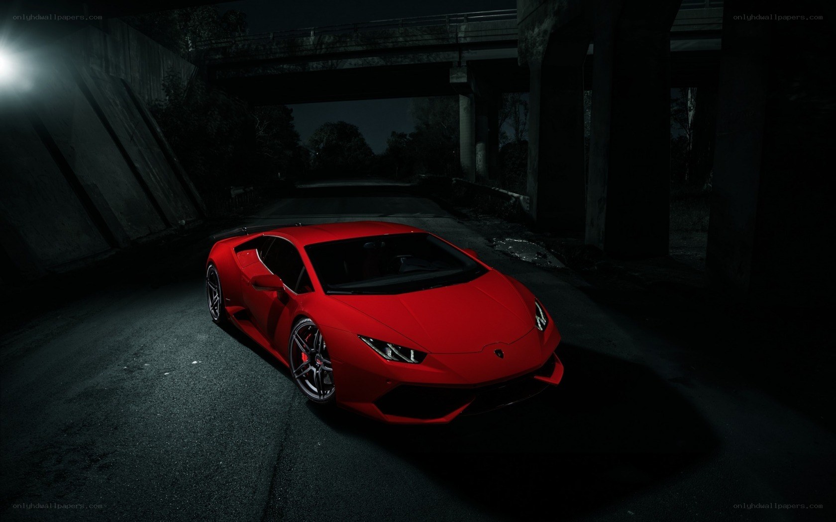 Red sports car under bridge