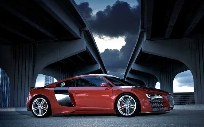 Red sports car under highway
