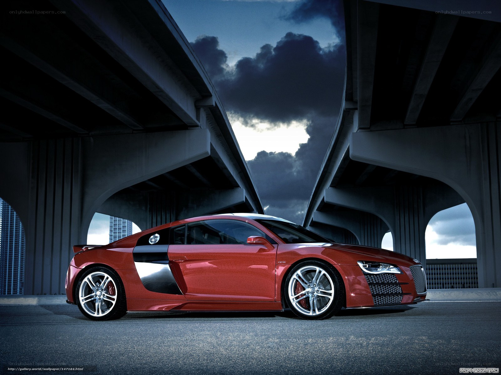Red sports car under highway