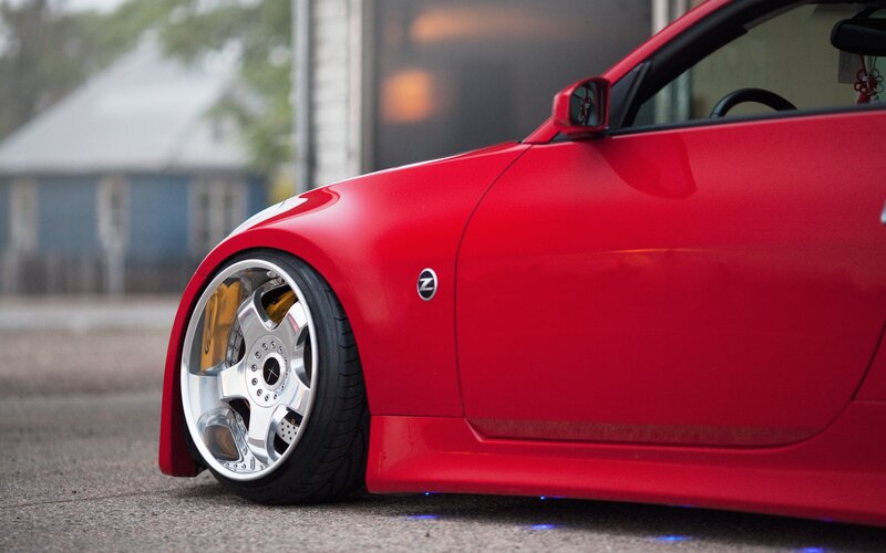 red sports car with custom wheels