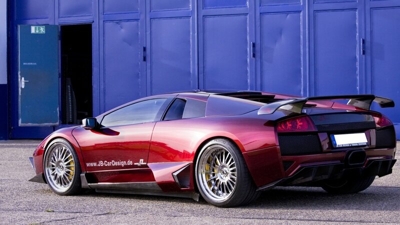 red sports car with custom wheels