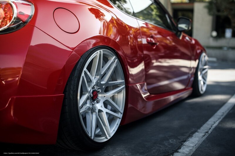 Red sports car with custom wheels