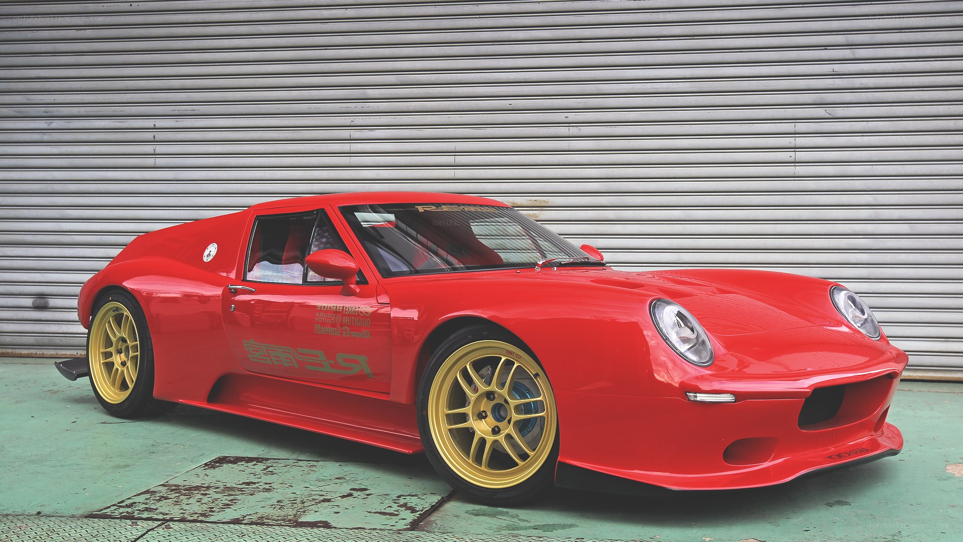 Red sports car with gold wheels