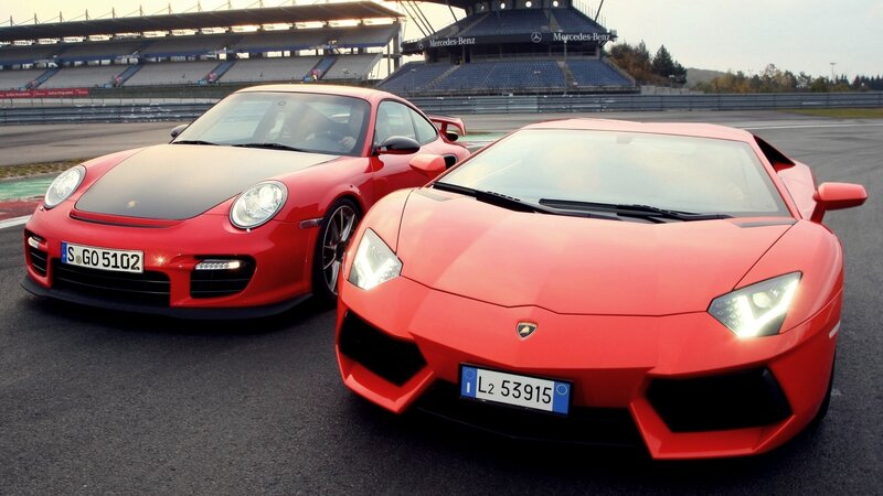Red sports cars on a racetrack