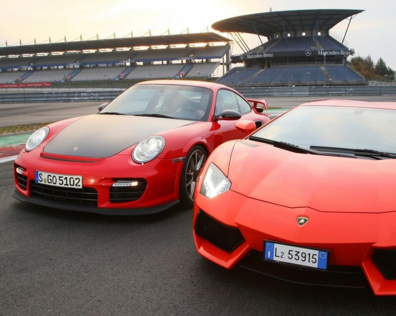 Red sports cars on a racetrack