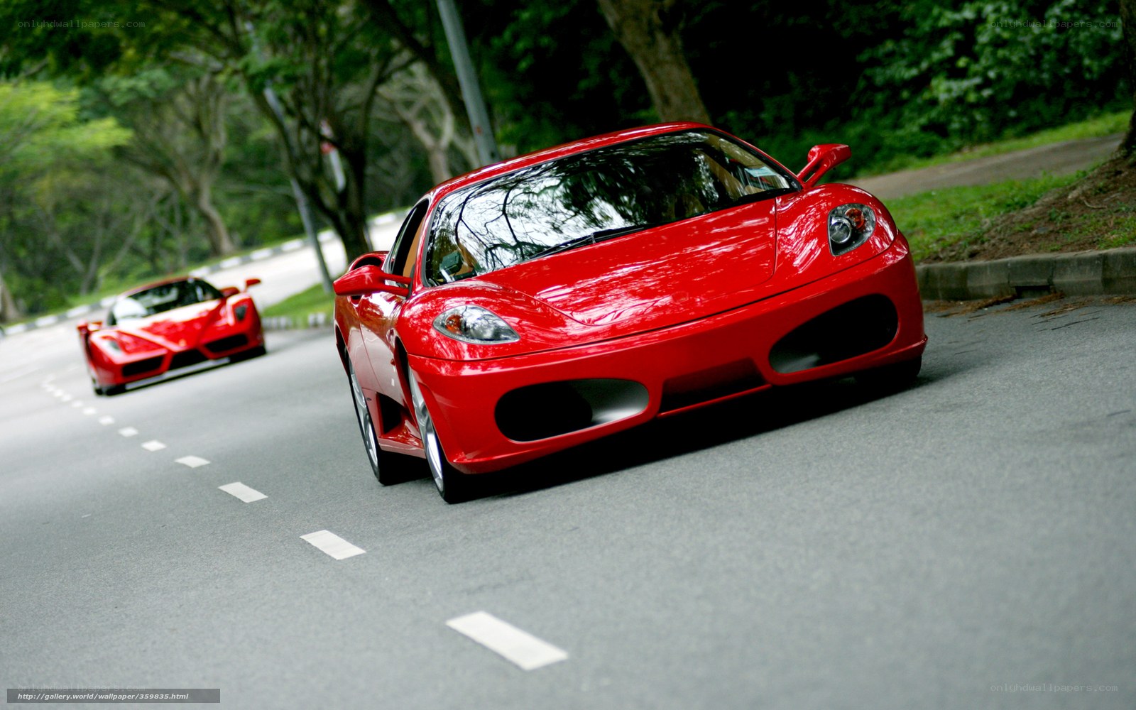 Red sports cars on a road