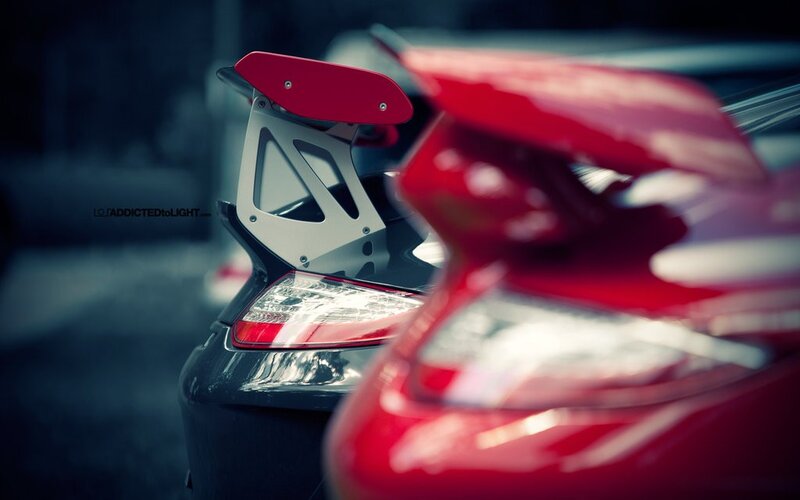 Red sports cars with rear wings