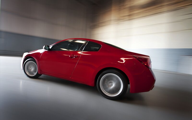 Red sports coupe in motion