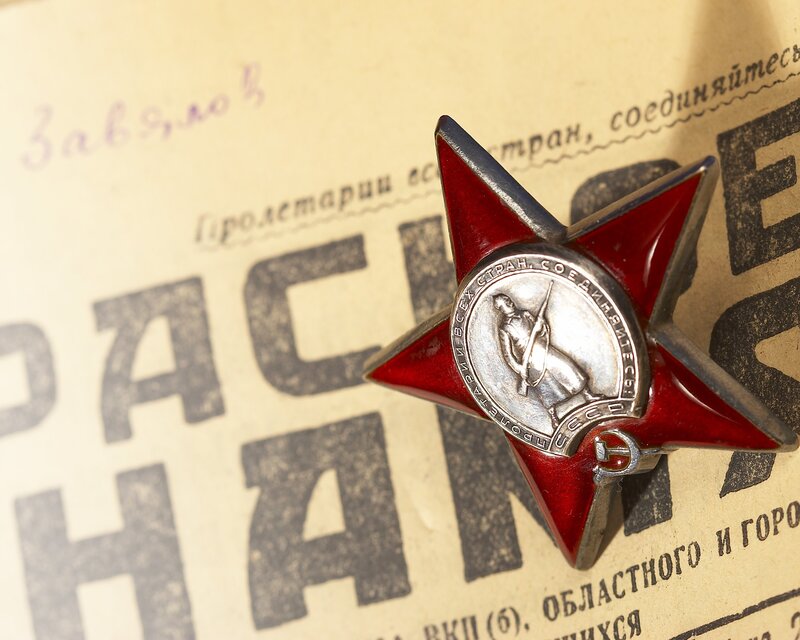 Red star medal on vintage paper