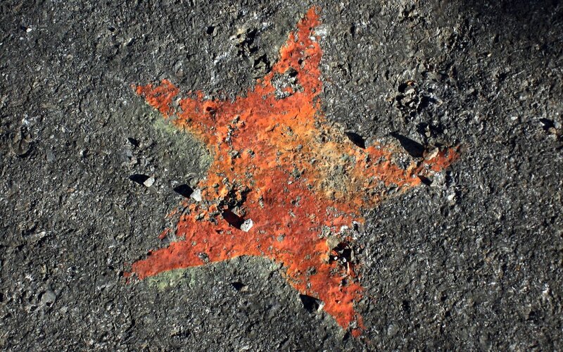 Red star painted on asphalt