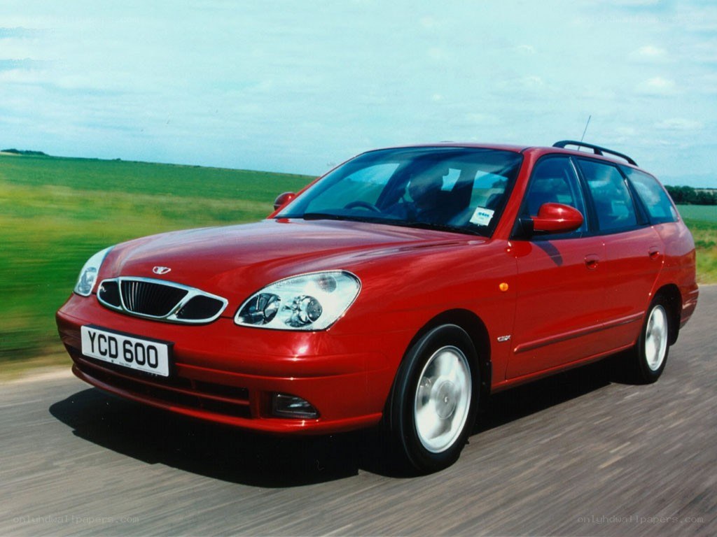 red station wagon driving on road