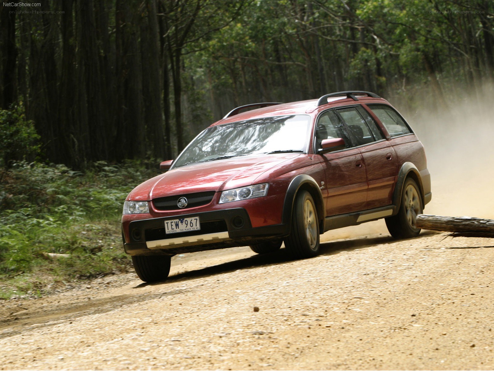 red station wagon on dirt road