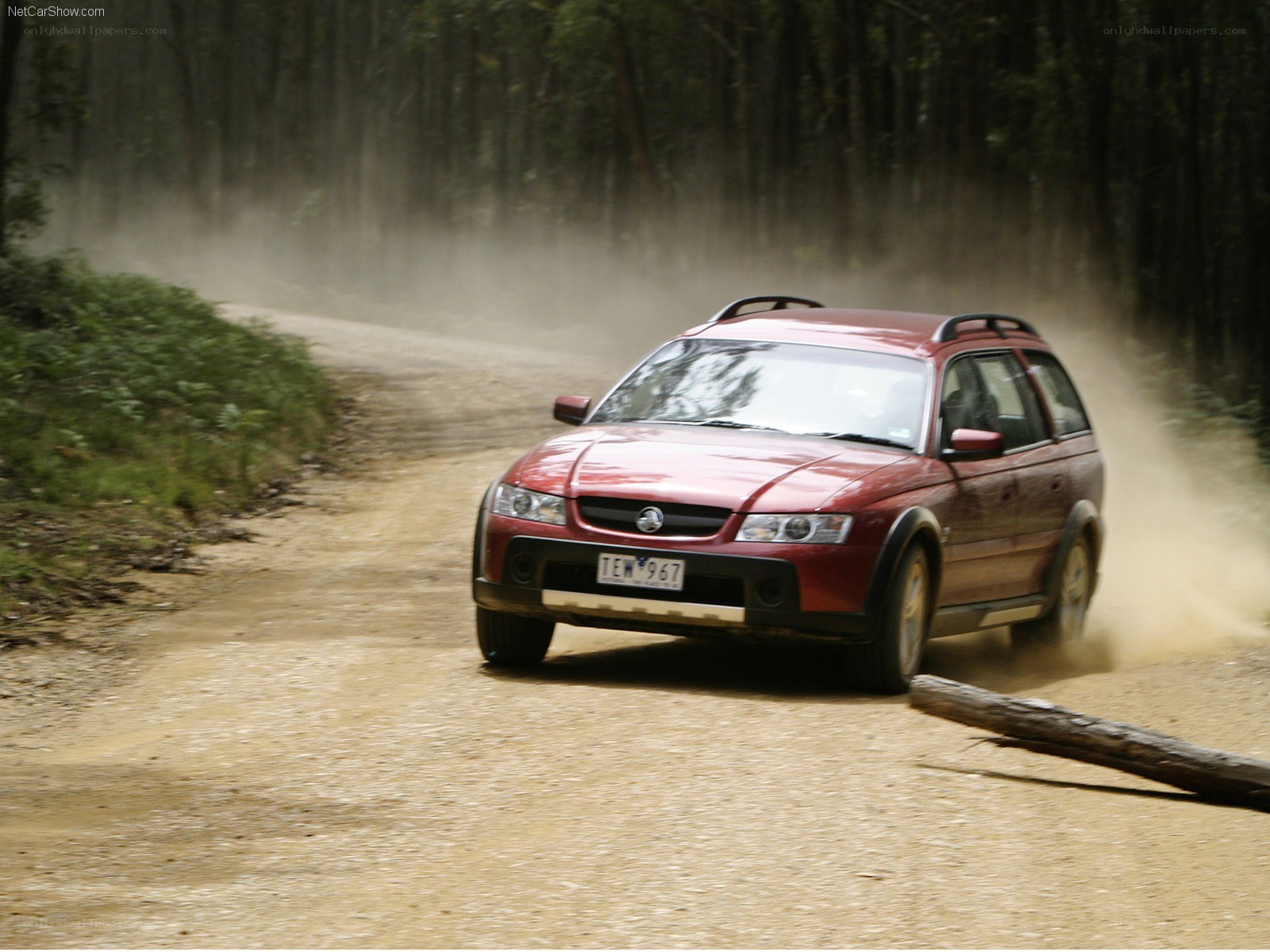 red station wagon on dirt road