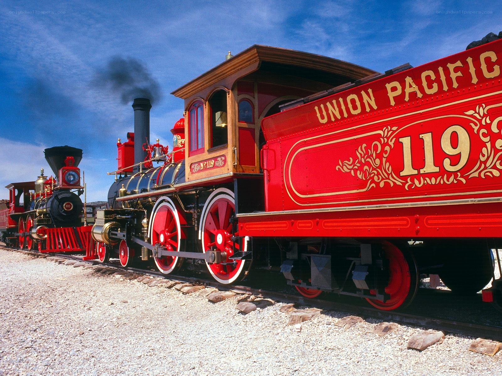 Red steam locomotives on tracks