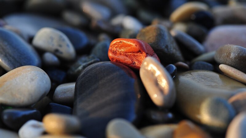 Red Stone Among Pebbles — Serene, Sunset