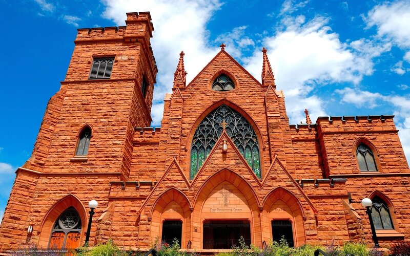 Red stone church with stained glass