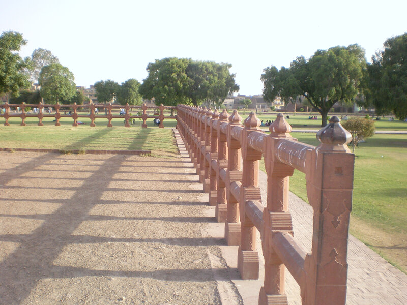 Red stone railing in a park