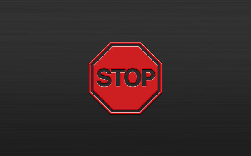 red stop sign on dark background
