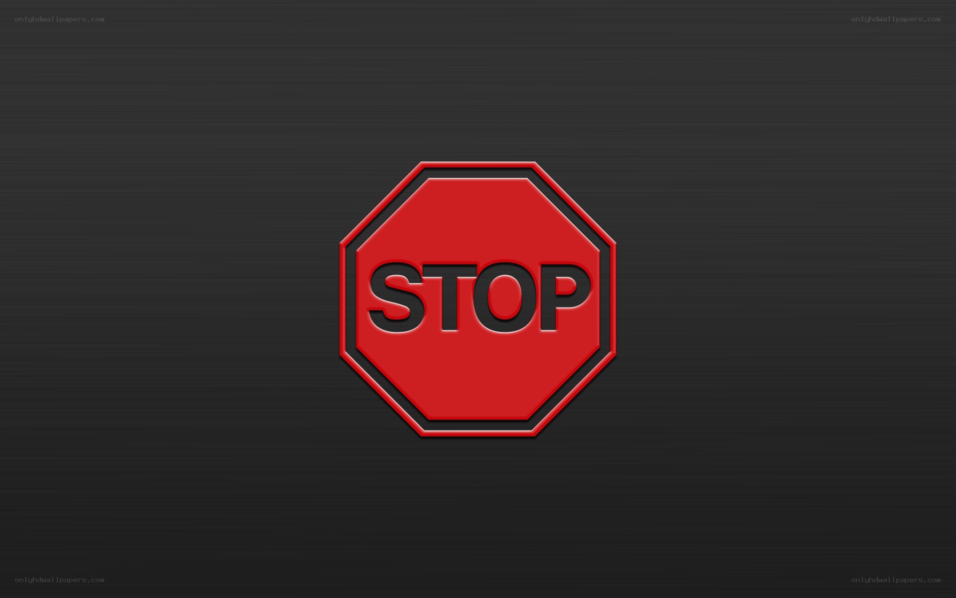 red stop sign on dark background