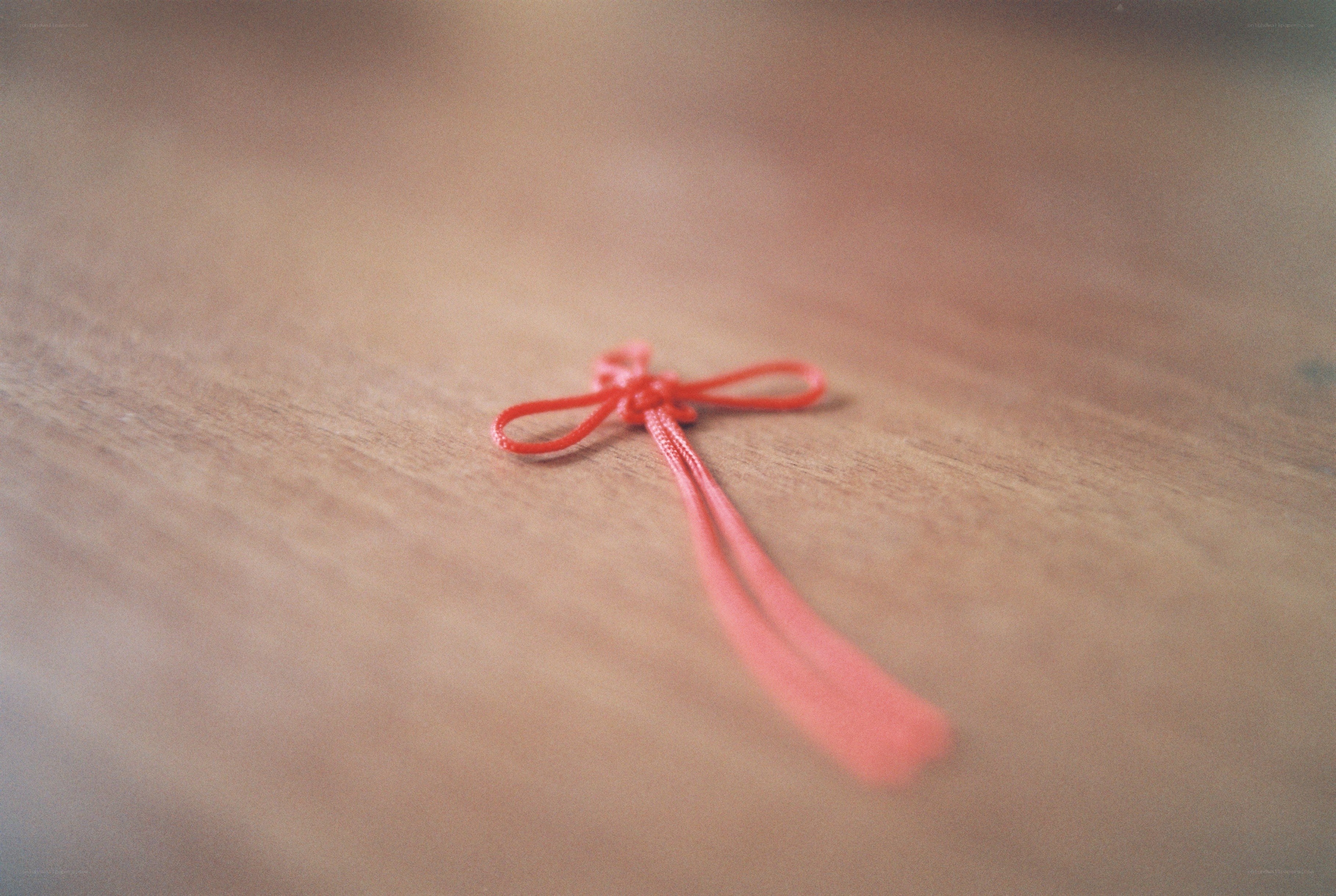 Red string on wood surface
