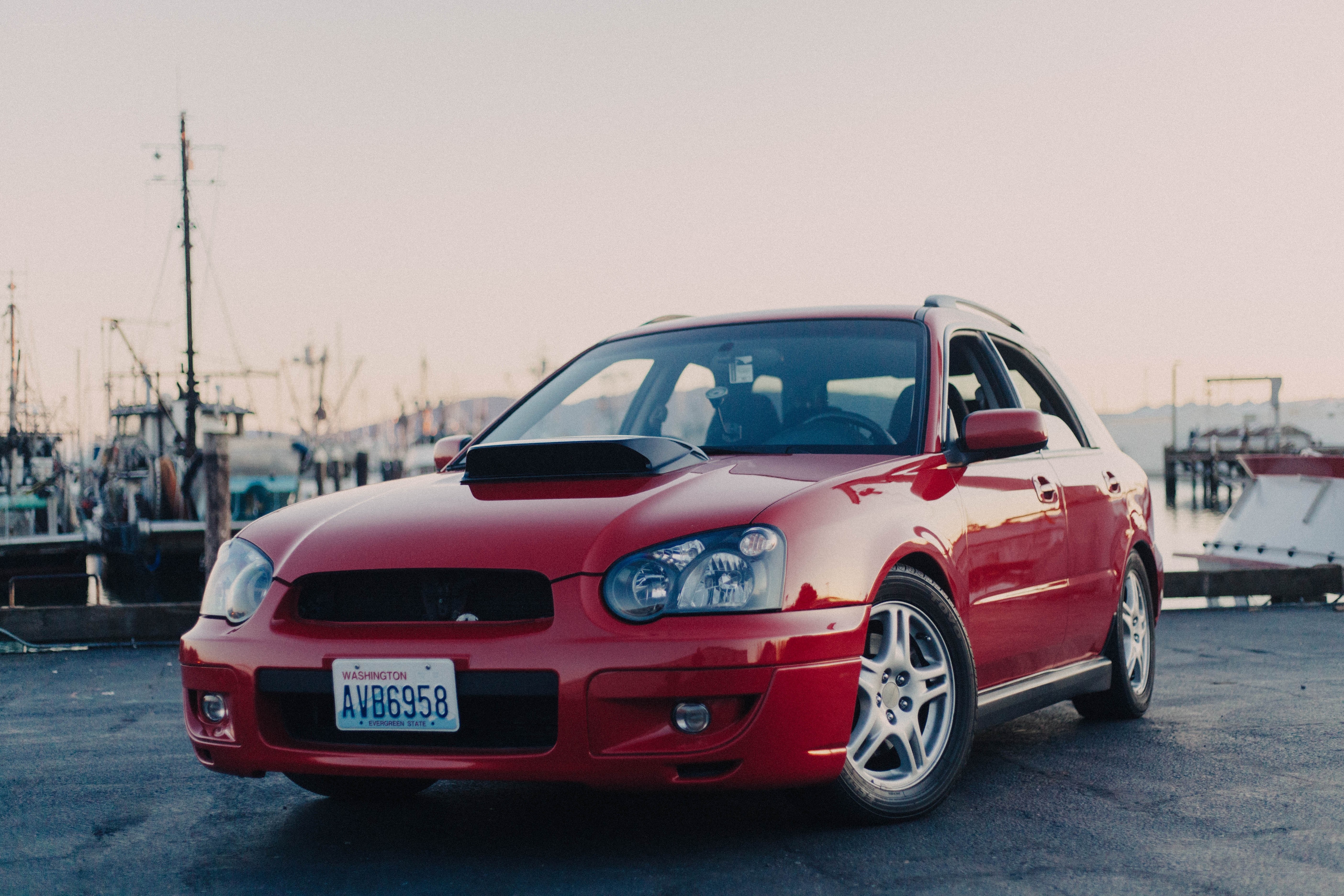 Red Subaru at a harbor
