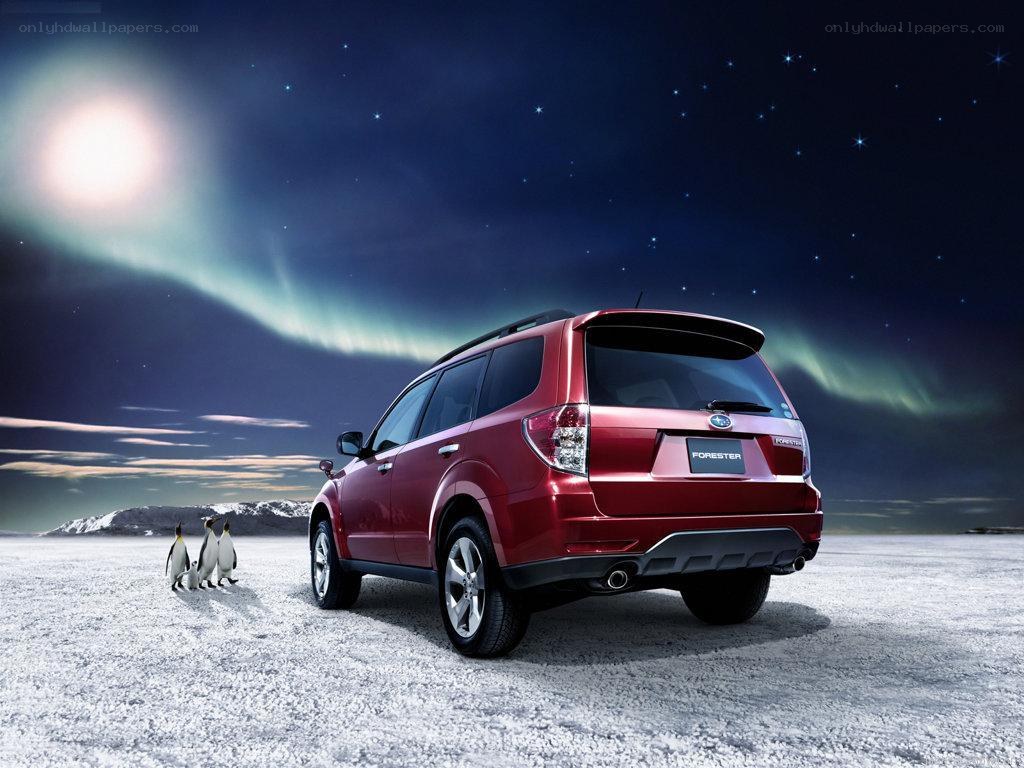 Red Subaru Forester under aurora