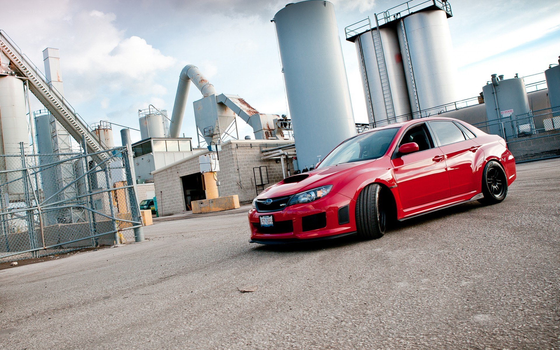 Red Subaru in industrial area