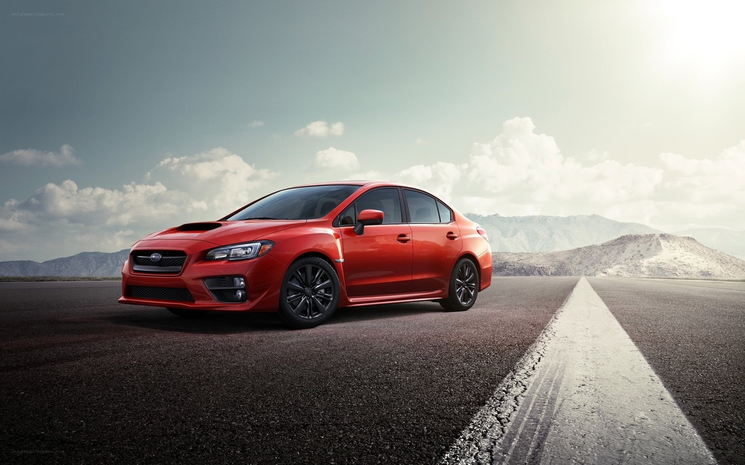 Red Subaru on a desert road