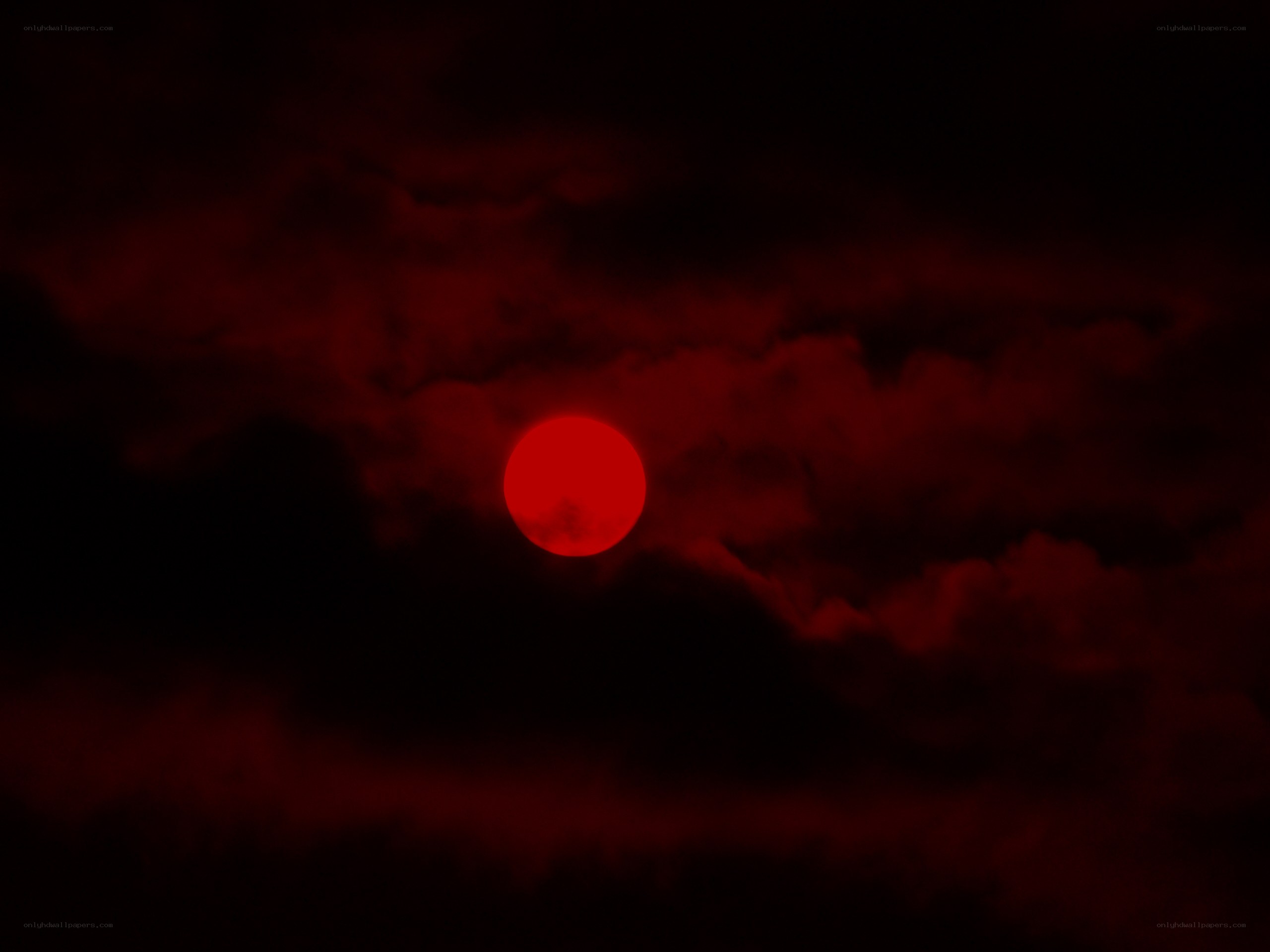 Red sun in dark clouds
