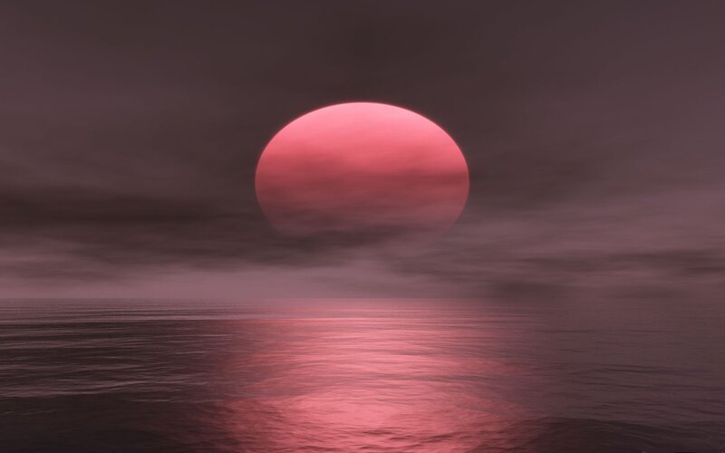 Red sun over calm sea