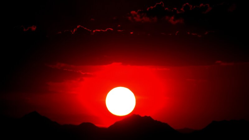 Red sun over mountains