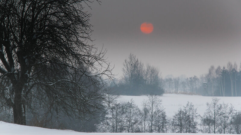 Red Sun over Snowy Field