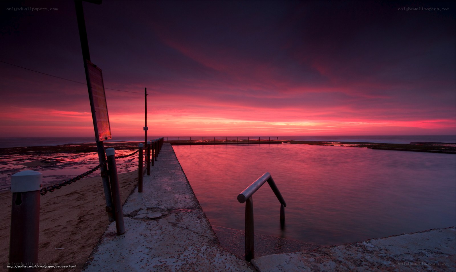 Red sunset at ocean pool