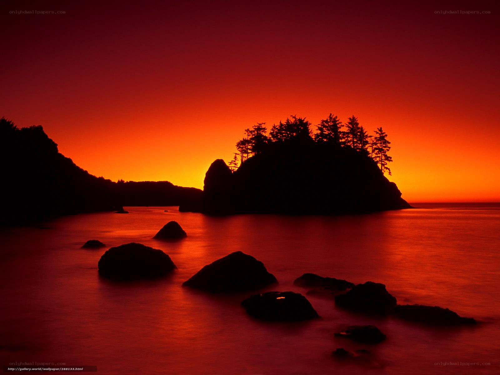 Red sunset over coastal rocks