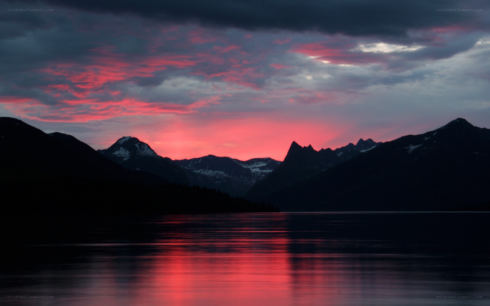 Red sunset over mountain lake