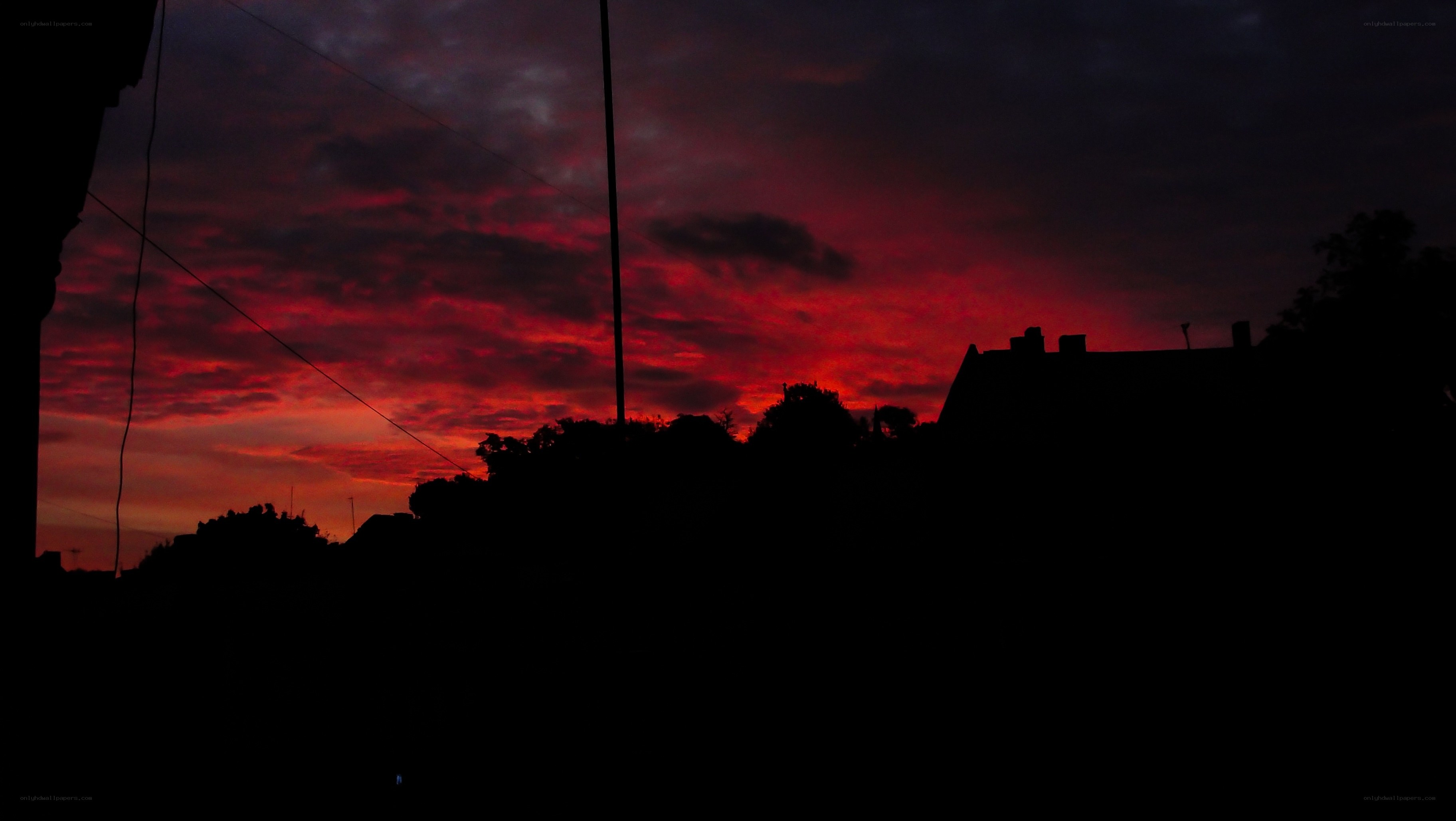 Red sunset over silhouetted town