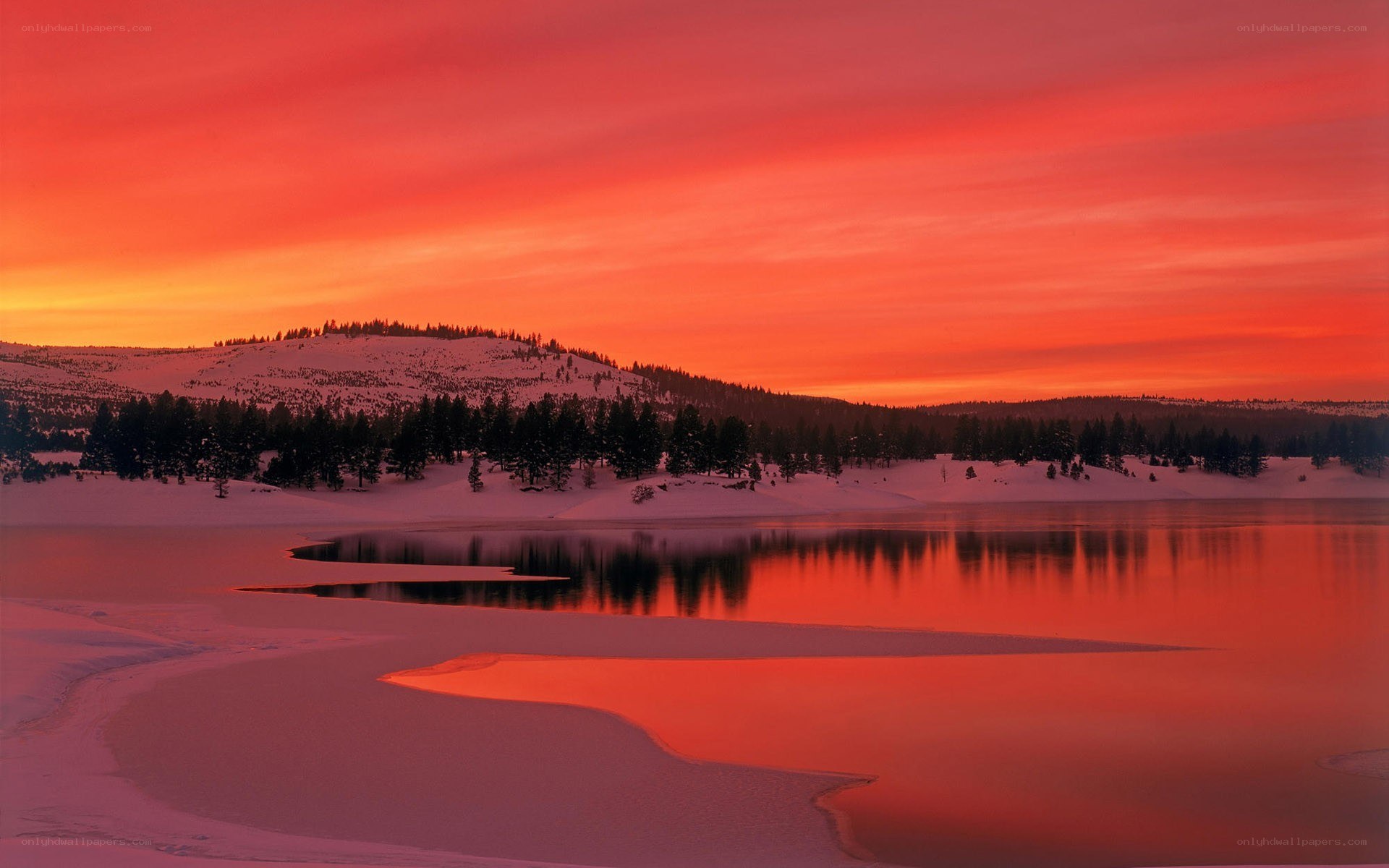 Red sunset over snowy lake
