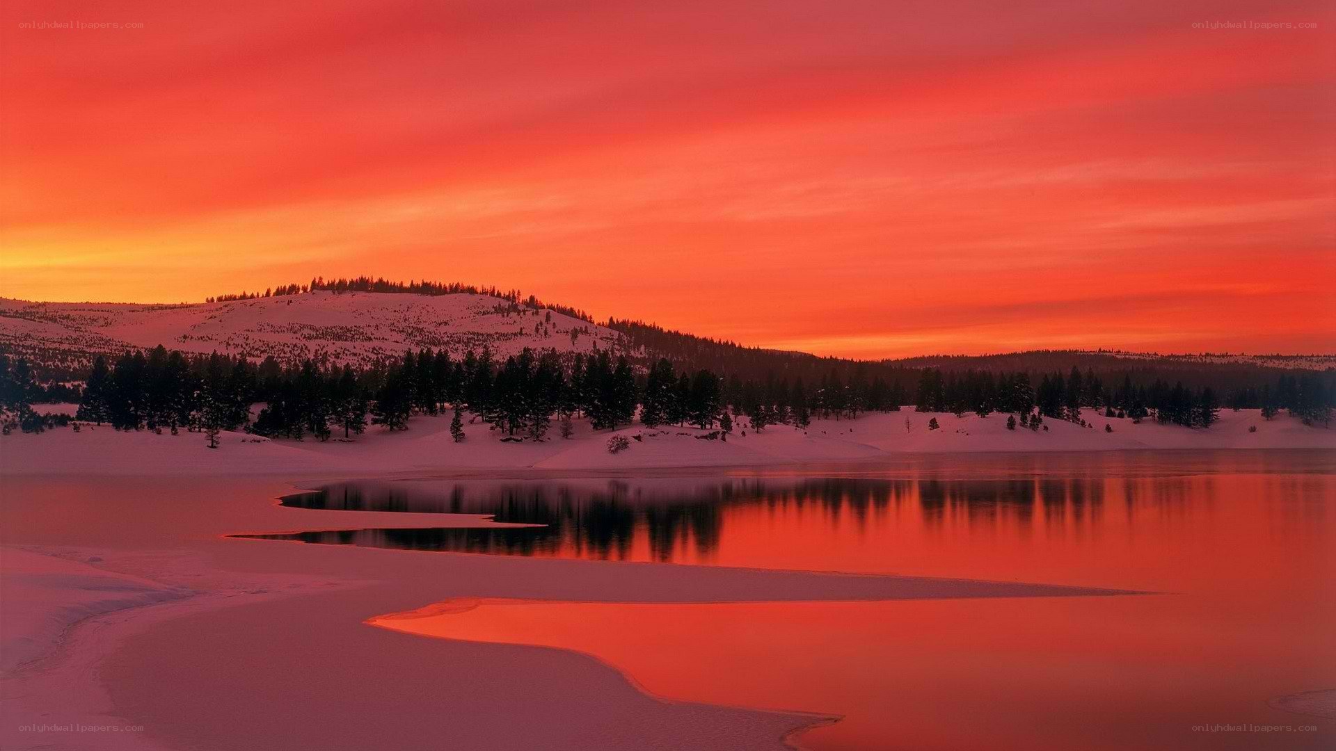 Red sunset over snowy lake
