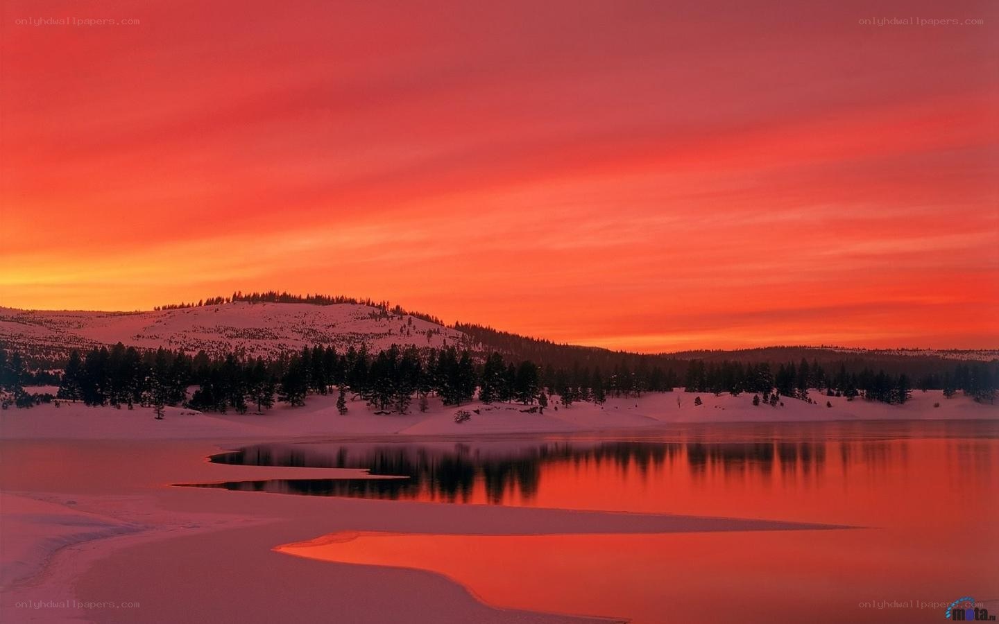 Red sunset over snowy lake