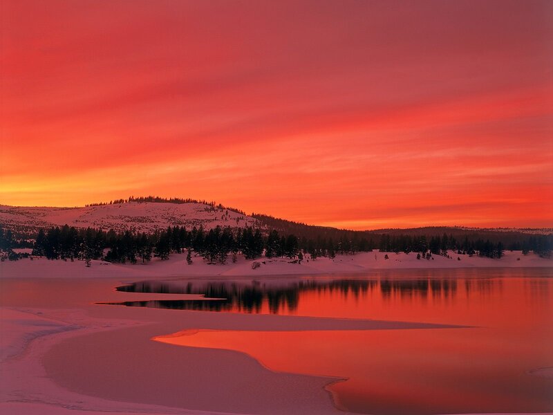 Red sunset over snowy lake