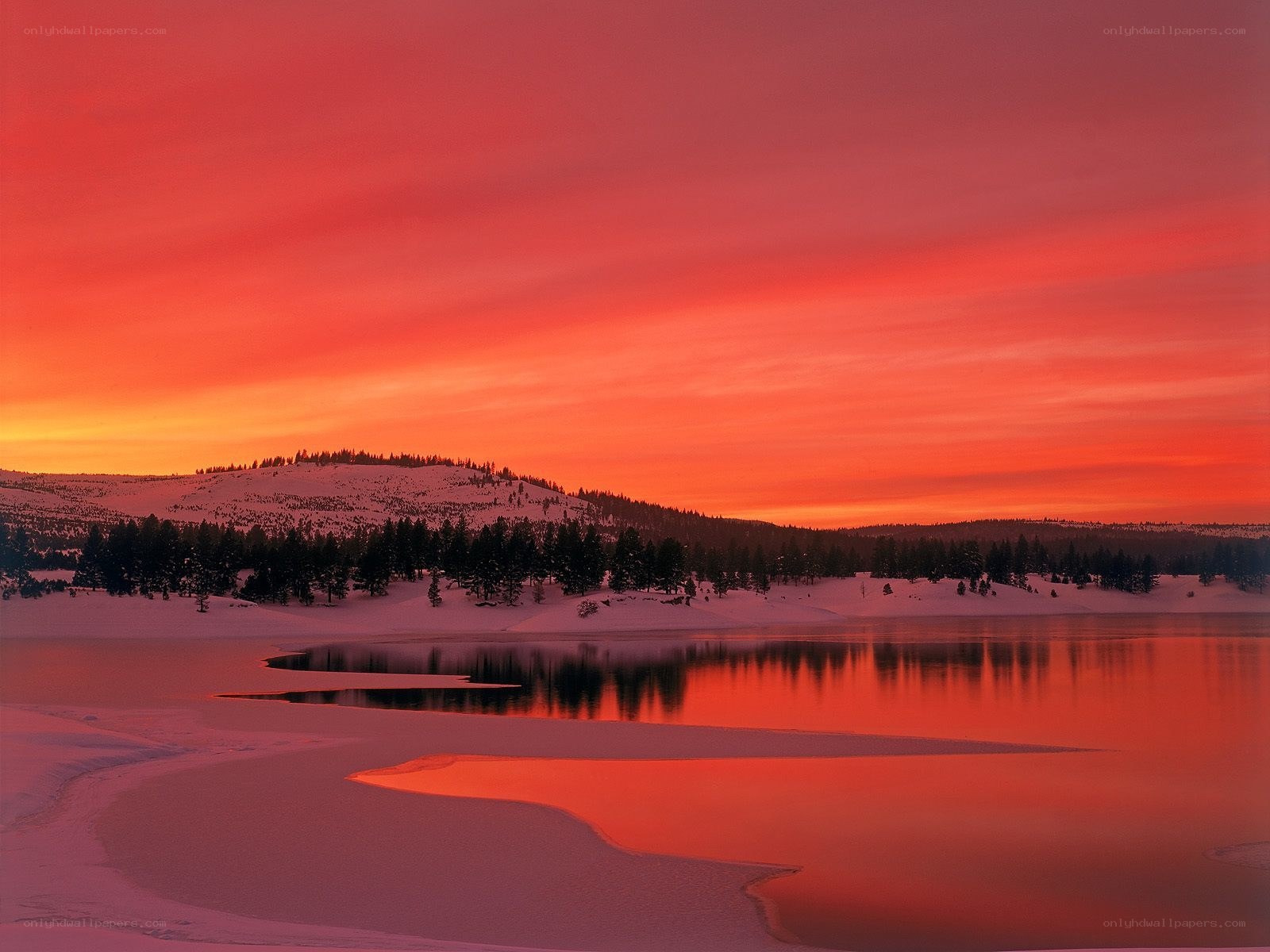 Red sunset over snowy lake