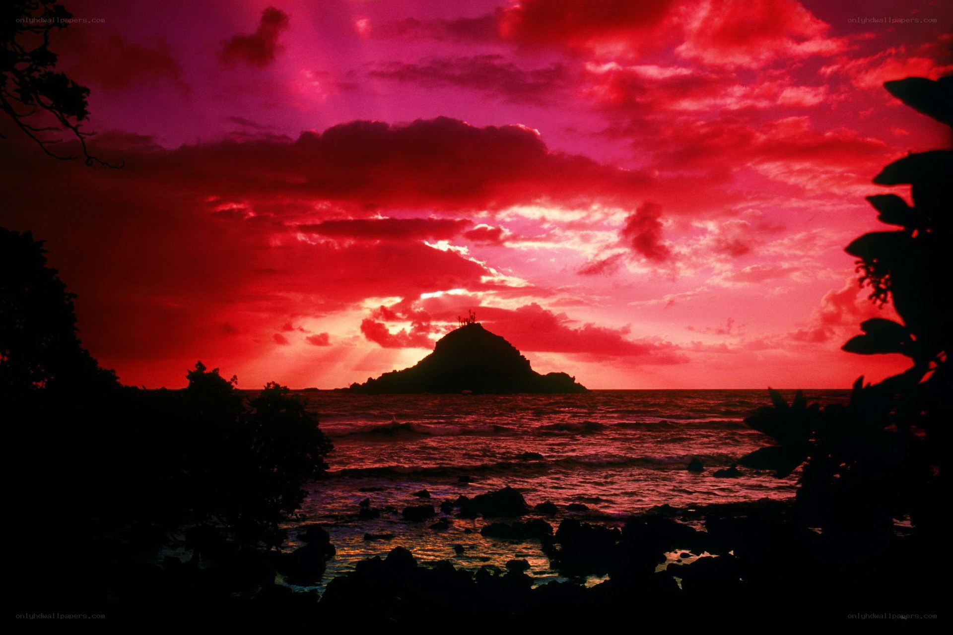Red sunset over volcanic island