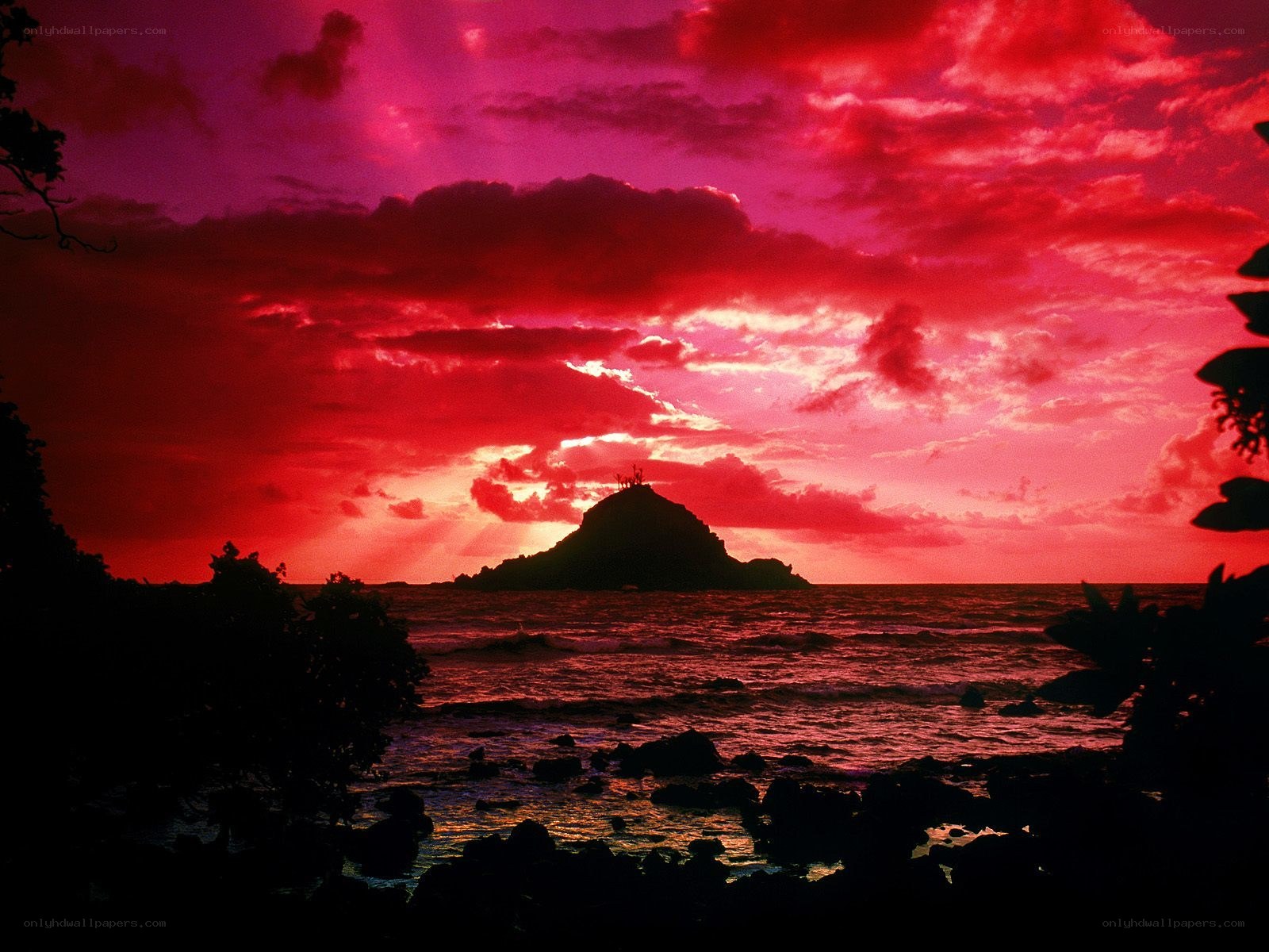 Red sunset over volcanic island